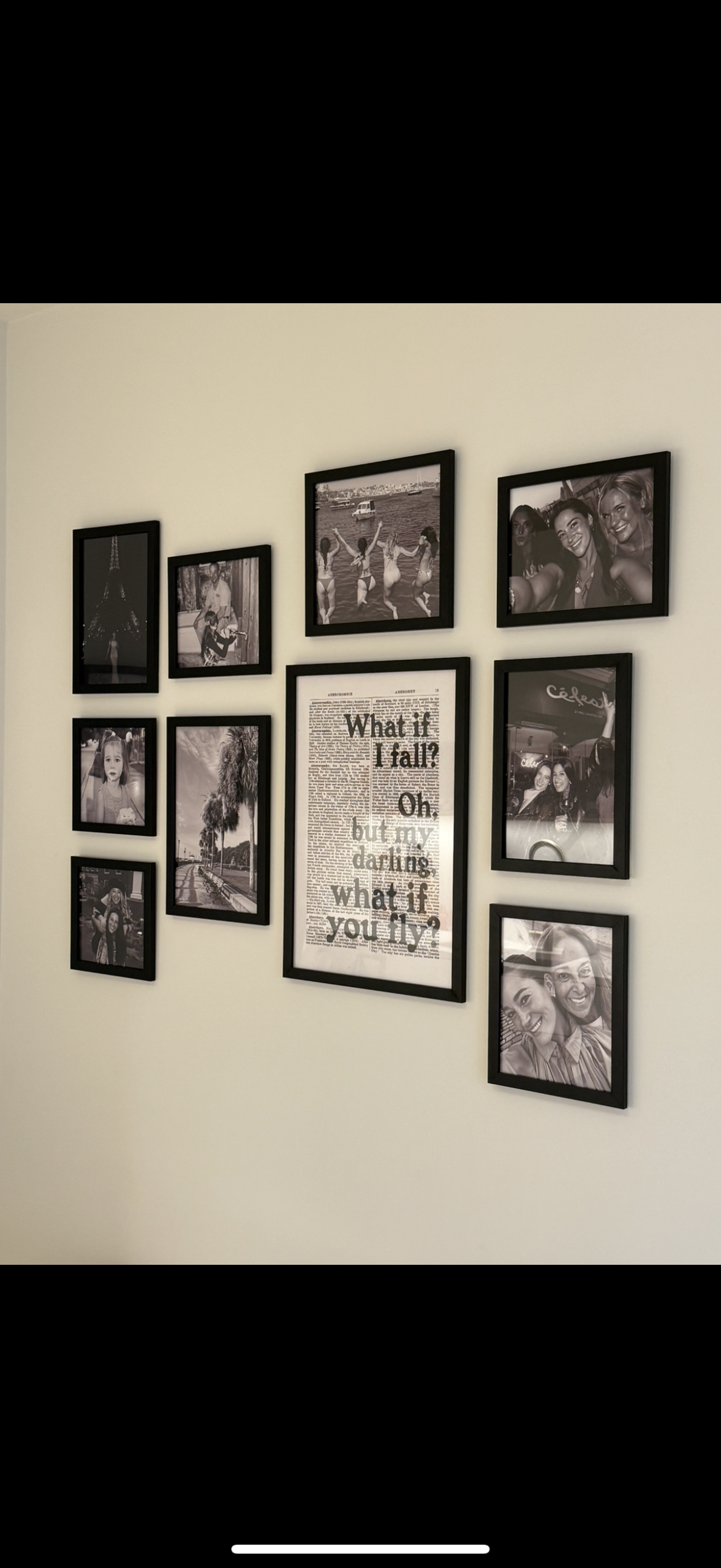10-frame black and white gallery wall installation in NYC apartment by Picture Perfect Mounting