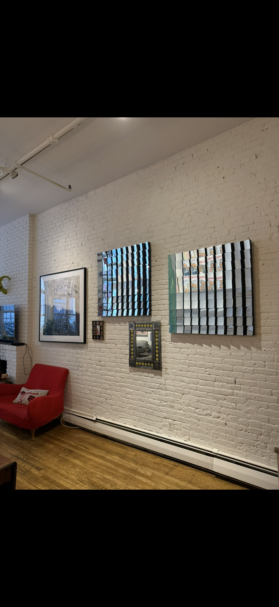 Mixed art gallery wall installation on brick wall NYC by Picture Perfect Mounting