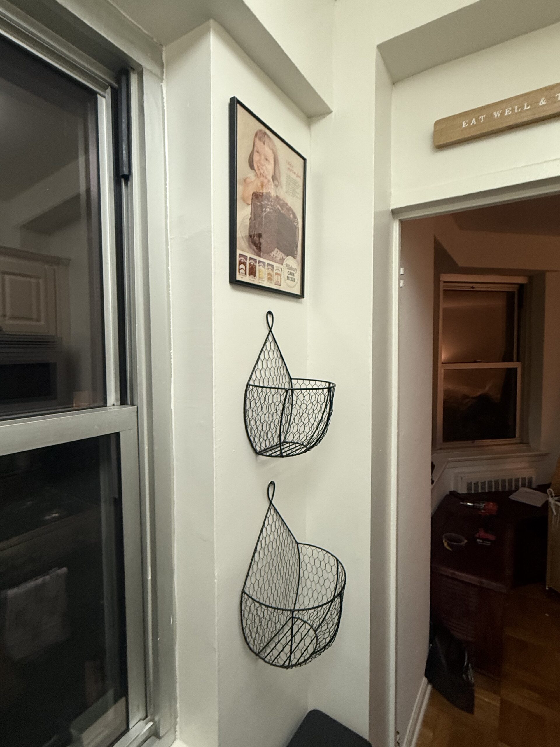 Small framed artwork installation on window sill NYC