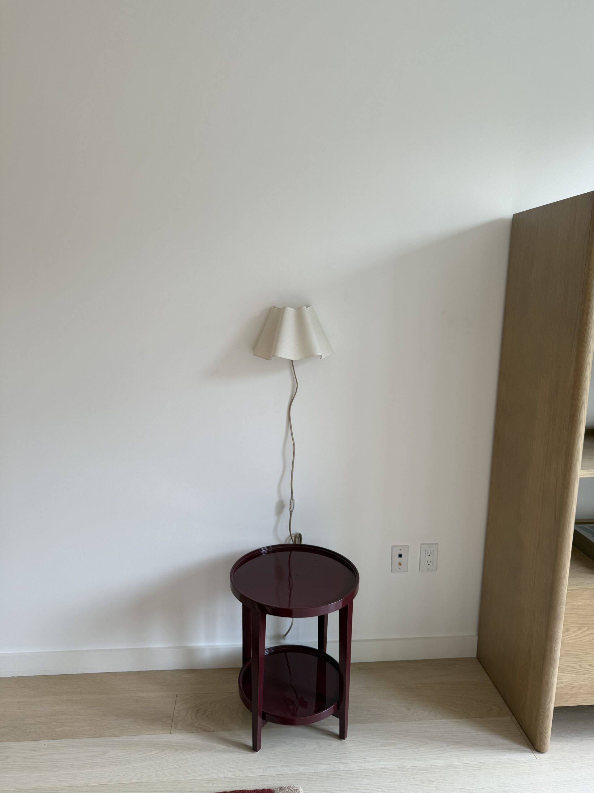 Wall shelf and lamp installation in NYC apartment