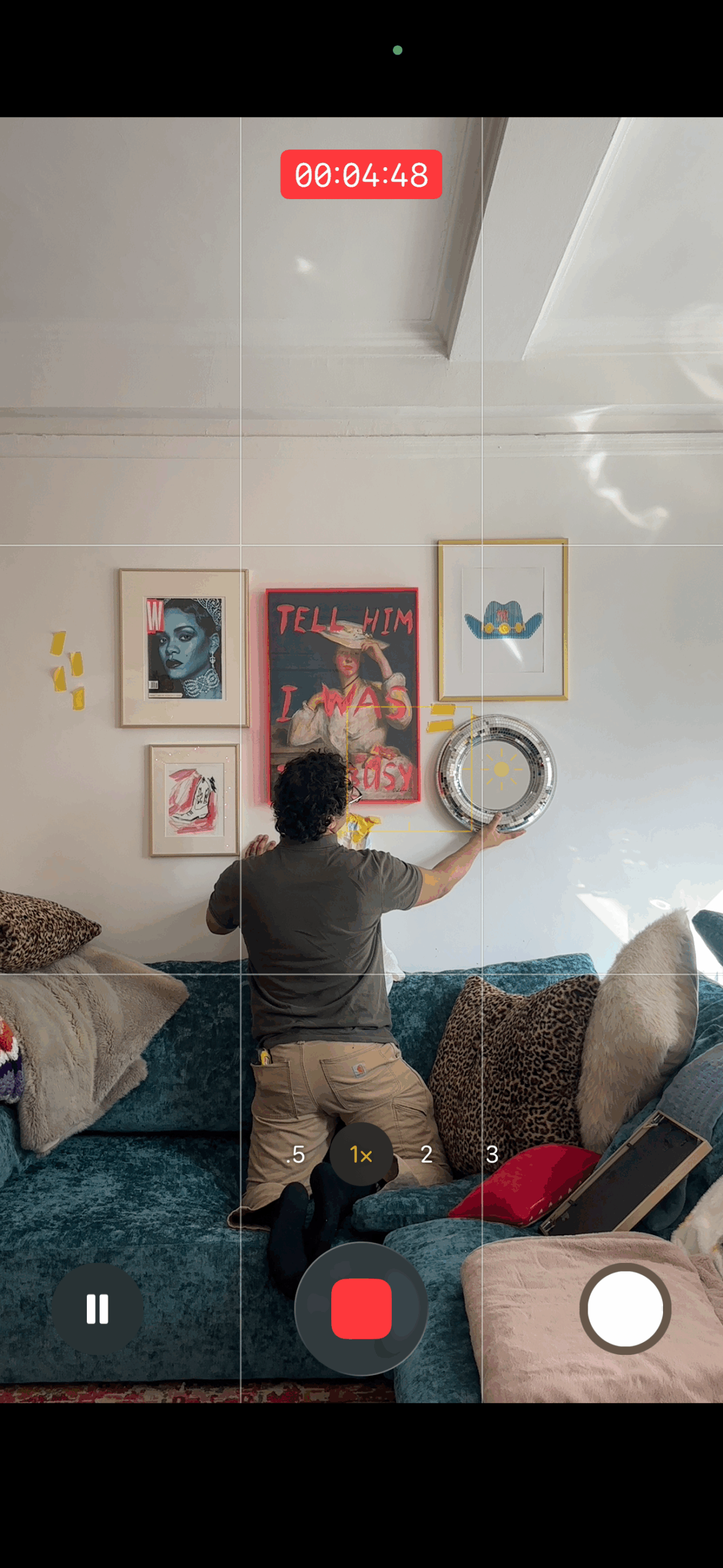 Professional gallery wall installer hanging frames in NYC apartment