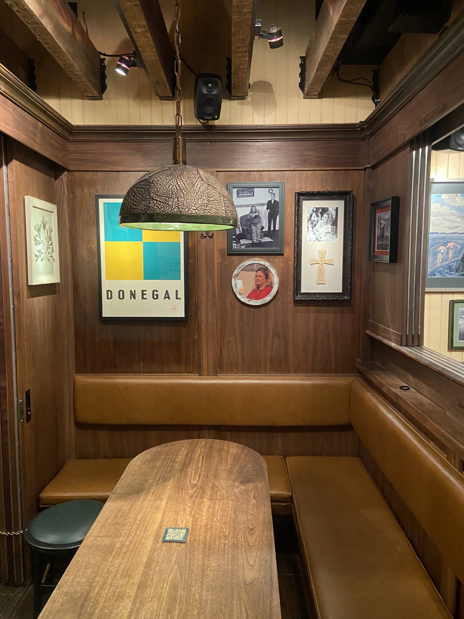 Framed artwork hung in a bar booth at The Dead Rabbit