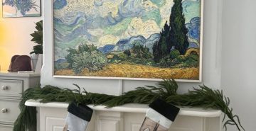 Samsung Frame TV displaying Van Gogh art mounted above white fireplace mantle, NYC brownstone with Christmas decor